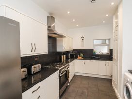 A kitchen with appliances and cabinets at Tennyson House Scarborough