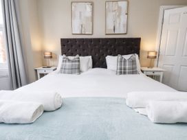 A bedroom with a bed and artwork at Tennyson House in Scarborough
