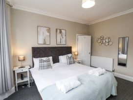 A bedroom with a double bed and bedside tables at Tennyson House in Scarborough