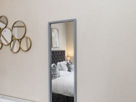 A bedroom with a bed and decorative mirrors at Tennyson House in Scarborough