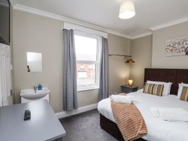 A bedroom with a bed and sink at Tennyson House in Scarborough