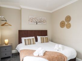 A bedroom with a bed and nightstand at Tennyson House in Scarborough