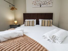 A bedroom with a bed and decorative items at Tennyson House in Scarborough
