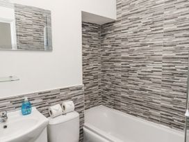 A bathroom with a bathtub, sink, and toilet at Tennyson House in Scarborough