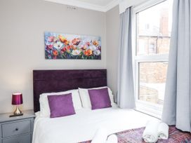 A bedroom with a bed, pillows, and a window at Tennyson House in Scarborough