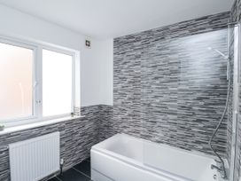 A bathroom with a shower and bathtub at Tennyson House in Scarborough