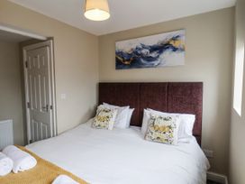 A bedroom with a bed and wall art at Tennyson House in Scarborough