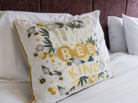 A decorative pillow with a design on a bed at Tennyson House in Scarborough