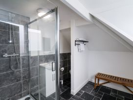 A bathroom with a shower, sink, and toilet at Tennyson House in Scarborough
