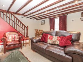 A living room with a sofa and armchair at Dove Cottage in Sleights