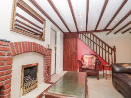 A living room with fireplace and seating area at Dove Cottage in Sleights