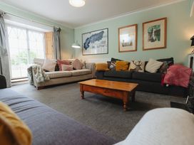 A living room with sofas and a coffee table at Cwmalis Hall in Llangollen
