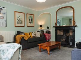 A living room with a sofa and coffee table at Cwmalis Hall in Llangollen