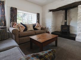 A living room with a sofa and wooden coffee table at Cwmalis Hall in Llangollen