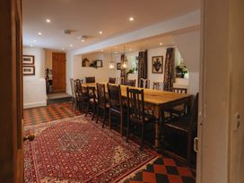 A dining room with a large table and chairs at Cwmalis Hall Llangollen