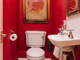 A bathroom with a toilet and sink at Cwmalis Hall in Llangollen