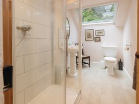 A bathroom with shower, toilet, and sink at Cwmalis Hall in Llangollen