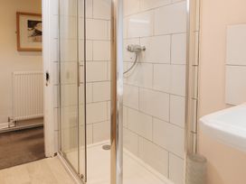 A bathroom with a shower and sink at Cwmalis Hall in Llangollen
