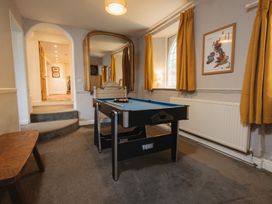 A games room with a pool table at Cwmalis Hall in Llangollen