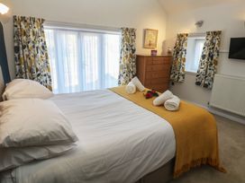 A bedroom with a bed and a dresser at Meadowside in Mousehole
