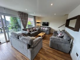 A living room with sofas and a television at Willow, Retallack near St Columb Major