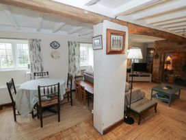 A living room with a dining area and sofa at Priors Mead in Claydon near Cropredy