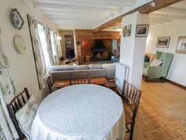 A living room with a table and sofa at Priors Mead in Claydon near Cropredy
