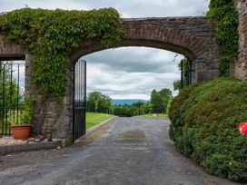 An archway with gates leading to a view of hills at Coach House Kilbeg near Borris-In-Ossory County Laois