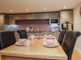 A kitchen with a dining table set in Tornado @ Engine Shed Whitby