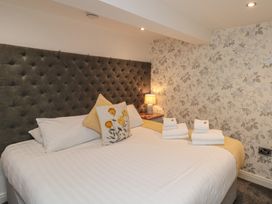 A bedroom with a bed and bedside table at Tornado @ Engine Shed in Whitby