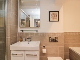 A bathroom with a sink, toilet and shower at Tornado @ Engine Shed Whitby