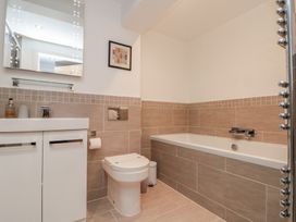 A bathroom with a bath tub and sink at Tornado @ Engine Shed in Whitby