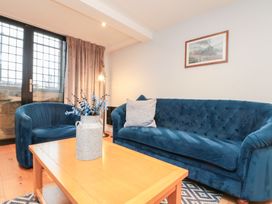 A living room with blue furniture and a window at Blue Peter @ Engine Shed Whitby