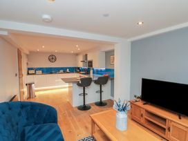 A kitchen with bar stools and a television at Blue Peter @ Engine Shed, Whitby