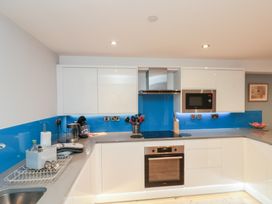 A kitchen with cabinets, oven, and microwave at Blue Peter @ Engine Shed Whitby