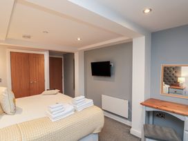 A bedroom with a bed, TV, and a table at Blue Peter @ Engine Shed in Whitby