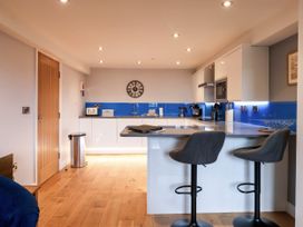 A kitchen with bar stools and modern fixtures at Blue Peter @ Engine Shed Whitby