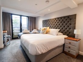 A bedroom with a bed and balcony doors at Blue Peter @ Engine Shed in Whitby