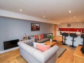 A living room with a sofa and kitchen island at Olton Hall @ Engine Shed in Whitby