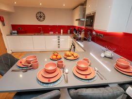 A kitchen with dishes and cups on the table at Olton Hall @ Engine Shed in Whitby
