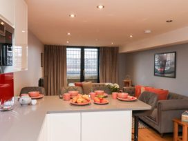 A kitchen with a sofa and dining table at Olton Hall @ Engine Shed, Whitby