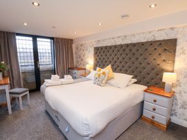 A bedroom with a bed and nightstand at Olton Hall @ Engine Shed Whitby