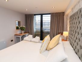 A bedroom with a bed and mirror at Olton Hall @ Engine Shed in Whitby