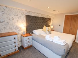 A bedroom with a bed and nightstands at Olton Hall @ Engine Shed Whitby