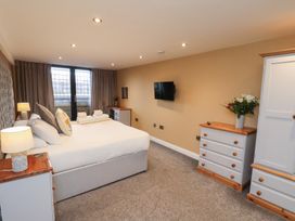 A bedroom with a bed and television at Olton Hall @ Engine Shed, Whitby