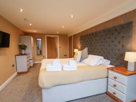 A bedroom with a bed and dresser at Olton Hall @ Engine Shed in Whitby