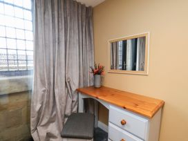 A bedroom with a desk and mirror at Olton Hall @ Engine Shed in Whitby