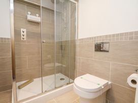 A bathroom with a shower and toilet at Olton Hall @ Engine Shed in Whitby