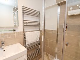 A bathroom featuring a wash basin, towel rail, and shower at Olton Hall @ Engine Shed, Whitby