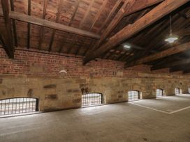 An indoor space with brick and stone walls and wooden ceiling at Olton Hall @ Engine Shed, Whitby